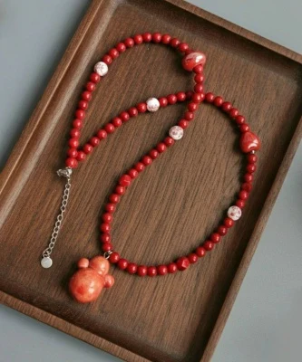Колье с неваляшкой